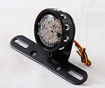 LED tail light with drilled black bezel for custom motorcycles.