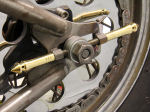 Custom brass and stainless steel axle adjusters for Harley Davidson Softails and rigid frames.