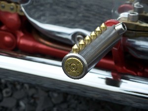 Hand made, nickel plated footpegs with solid brass inserts for grip. Note the polished 50 caliber brass shell used to plug the end of the peg.