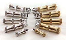 Assortment of DeVille Cycles HourGlass solid brass and aluminum foot pegs.