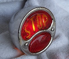 Model A tail light from DeVille Cycles with "STOP" script molded in the lens.